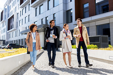Image showing people with coffee and conference badges in city