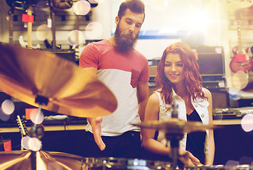 Image showing couple of musicians with drum kit at music store