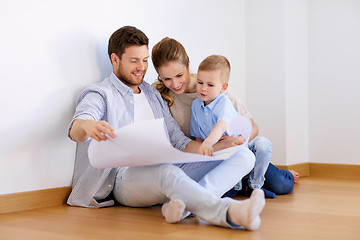 Image showing happy family with blueprint moving to new home