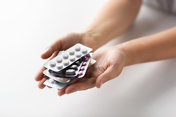 Image showing woman hands holding packs of pills