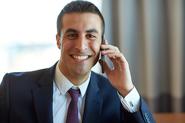 Image showing businessman calling on smartphone at hotel room