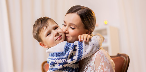 Image showing happy mother hugging and kissing her little son