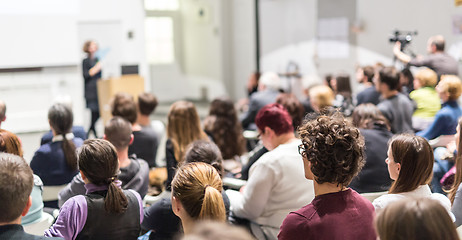 Image showing Woman giving presentation in lecture hall at university.