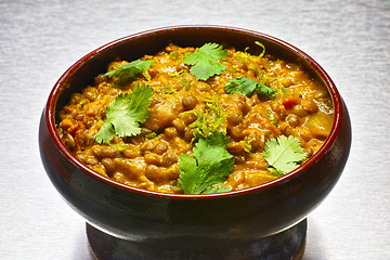 Image showing Moong Dal, indian vegetarian lentil soup in terra cotta bowl.