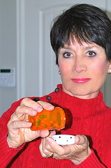 Image showing Taking vitamin pills.