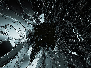 Image showing Pieces of shattered or smashed glass on black