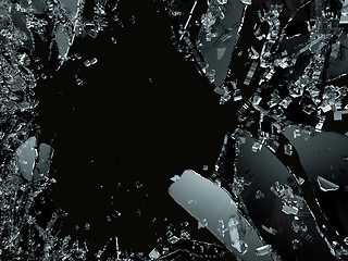 Image showing Pieces of splitted or cracked glass on black