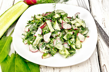 Image showing Salad of radishes and sorrel with mayonnaise in plate on board