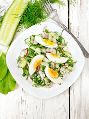 Image showing Salad with radish and egg in plate on board top