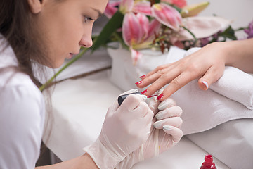 Image showing Woman hands receiving a manicure