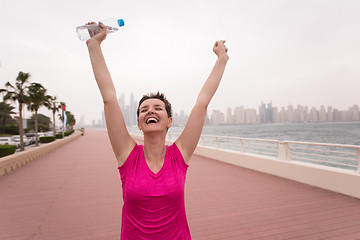 Image showing young woman celebrating a successful training run