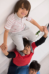 Image showing young boys posing line up piggyback top view