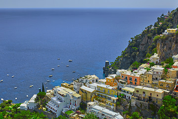 Image showing One of the best resorts of Italy with old colorful villas on the steep slope, nice beach, numerous yachts and boats in harbor and medieval towers along the coast, Positano.