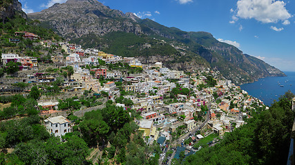 Image showing One of the best resorts of Italy with old colorful villas on the steep slope, nice beach, numerous yachts and boats in harbor and medieval towers along the coast, Positano.