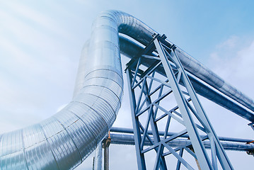 Image showing Industrial zone, Steel pipelines and valves against blue sky