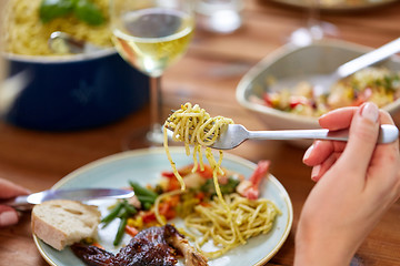 Image showing hands of woman eating pasta