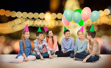 Image showing happy smiling children in party hats at birthday