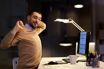 Image showing man with computer working late at night office