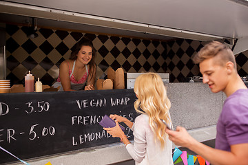 Image showing happy customers queue at food truck