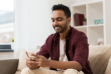 Image showing happy man with smartphone at home