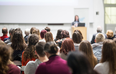 Image showing Woman giving presentation in lecture hall at university.