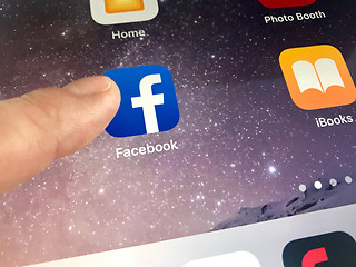 Image showing Macro image of a finger about to click the Facebook icon on an iPad screen