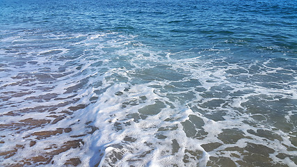 Image showing Sea wave with white foam on the beach