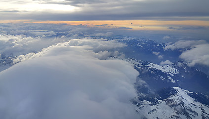 Image showing Top view on the Alps, covered with snow and clouds