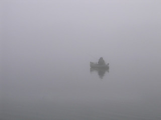 Image showing Lone fisherman on the river in a fog