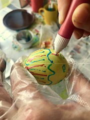 Image showing Woman painting an easter egg for holiday