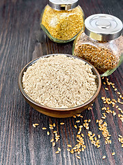 Image showing Flour linen in bowl with seeds in jars on wooden board