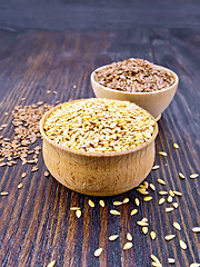 Image showing Flaxen white and brown seed in bowl on dark board