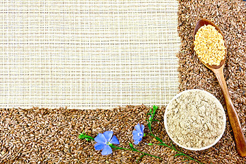 Image showing Flour and flax seeds with flowers on coarse woven fabric