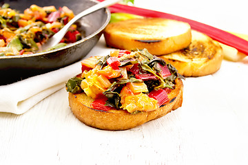 Image showing Bruschetta with chard and orange on light board