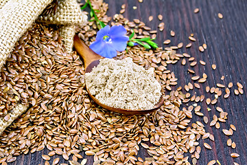 Image showing Flour flax in spoon with flower on dark board