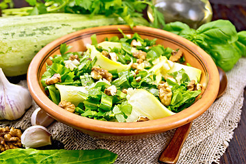 Image showing Salad with squash and sorrel in plate on dark board