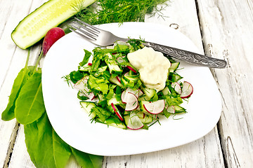 Image showing Salad with radishes and sorrel in plate on board