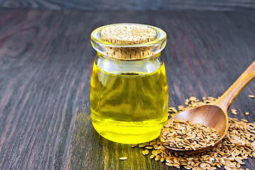 Image showing Oil linenseed with spoon on board