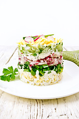 Image showing Salad layered with radish and cucumber on board