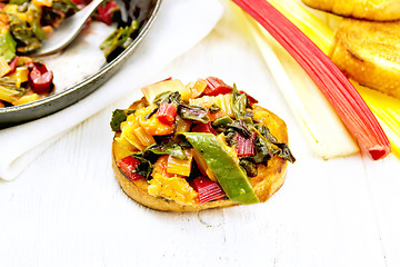 Image showing Bruschetta with chard and orange on table