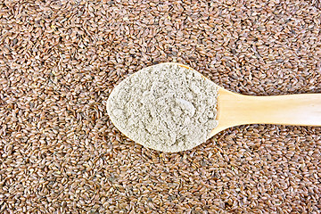 Image showing Flour linen in wooden spoon on seeds