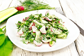 Image showing Salad of radishes and sorrel with mayonnaise in plate on light b