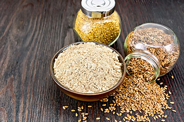 Image showing Flour linen in bowl with seeds in glass jars on board