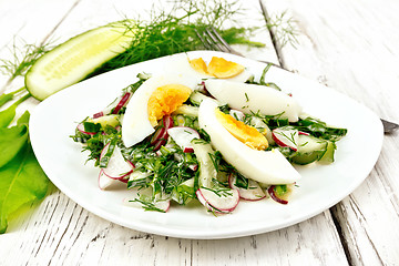 Image showing Salad with radish and egg in plate on light board