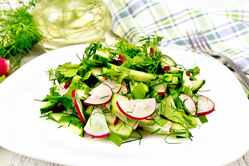 Image showing Salad of radish and sorrel with oil in plate on table