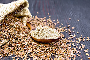 Image showing Flour flax in spoon with seeds and bag on board