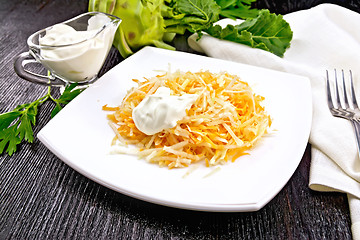 Image showing Salad of carrot and kohlrabi with sour cream in plate on black b