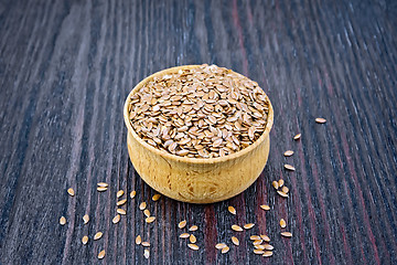 Image showing Flaxen brown seed in bowl on board