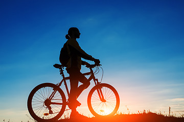 Image showing Silhouette of a bike on sky background