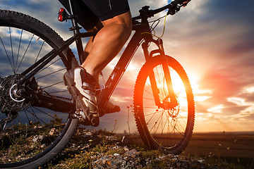 Image showing Closeup of cyclist man legs riding mountain bike